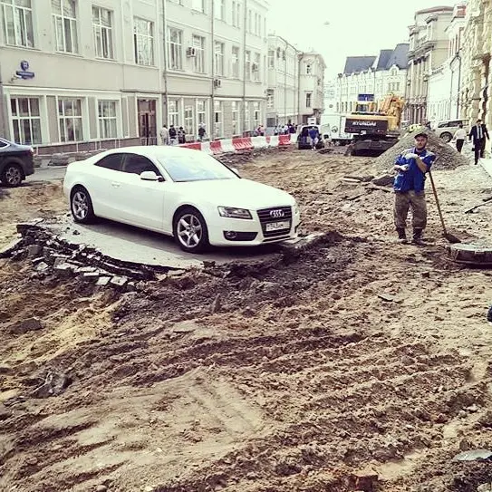 Москва марказидаги кўчада қолдирилган Audi’нинг атрофидаги йўлни таъмирчилар қазиб кетди (фото)